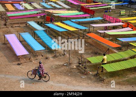 Shantipur, India. 14th Jan, 2023. A view of colourful Indian sarees drying under sun. The saree is a traditional form of dress for women in India. In Santipur & Fulia in the Nadia district of West Bengal, India 90 % of the population are engaged in weaving activities, and have been for generations. Credit: SOPA Images Limited/Alamy Live News Stock Photo