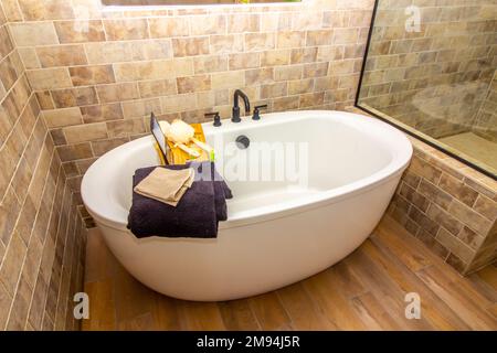 Modern Oval Bathtub With Bath Tray Stock Photo