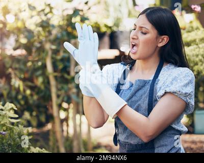 No pain , no gain. a young female florist suffering from wrist pain at work. Stock Photo