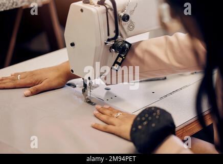 Custom made just for you. a seamstress using a sewing machine while working in her boutique. Stock Photo