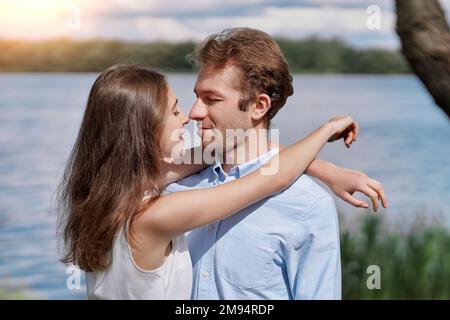 young couple kisses during a country walk . Stock Photo