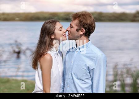 young couple kisses during a country walk . Stock Photo