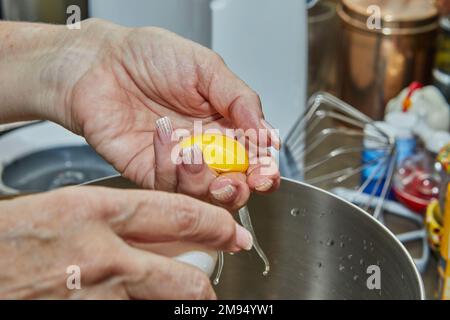 Chef separates the yolk from the protein to make the pie Stock Photo