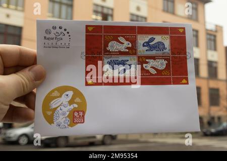 Budapest. 16th Jan, 2023. This photo taken on Jan. 16, 2023 shows a first-day cover with the stamps marking the Year of the Rabbit in Budapest, Hungary. A commemorative postage stamp marking the Chinese Lunar New Year (2023, Year of the Rabbit) was issued here on Monday. The stamp was issued by Hungary's Stamp Museum in collaboration with the Chinese Embassy in Hungary, the country's Ministry of Economic Development, the China Cultural Center in Budapest and the Hungarian Post Office. Credit: Attila Volgyi/Xinhua/Alamy Live News Stock Photo