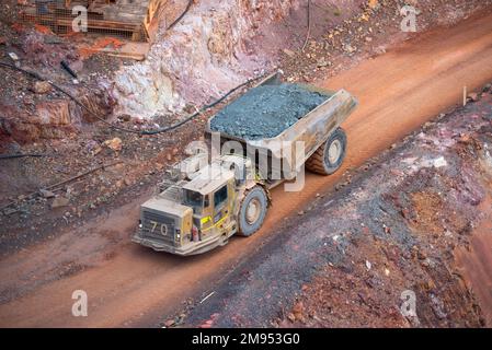 A lone haul truck makes its way up and out of the open pit of the Peak Gold Mines, New Cobar mine near the town of Cobar in northwest New South Wales Stock Photo