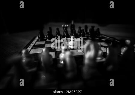 The set of wooden chess pieces element, king, queen rook, bishop, knight, pawn standing on chess board on dark background. Leadership, teamwork Stock Photo