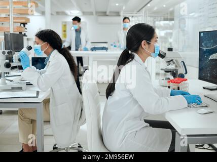 Separate but together in the zone. two female scientists working together in the lab. Stock Photo