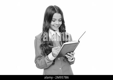 Happy school kid do written homework assignment writing in exercise book with pen, schooling Stock Photo