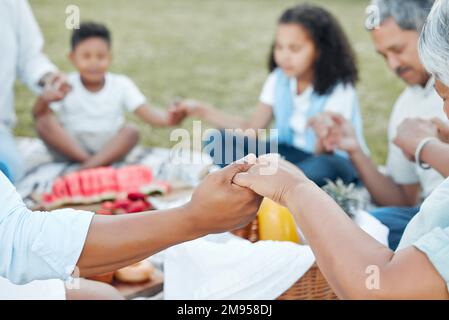 The memories we make with our family is everything. a unrecognizable family having lunch together outside in the garden. Stock Photo