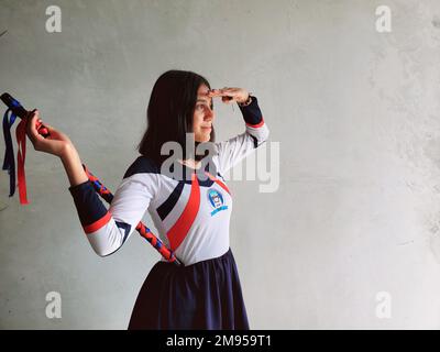 Cheerful Guatemalan high school girl in a marching band majorette costume during the Independence Day in rural Guatemala near Antigua Guatemala Stock Photo