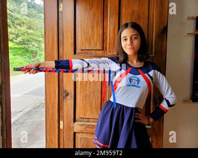 Cheerful Guatemalan high school girl in a marching band majorette costume during the Independence Day in rural Guatemala near Antigua Guatemala Stock Photo