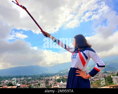 Cheerful Guatemalan high school girl in a marching band majorette costume during the Independence Day in rural Guatemala near Antigua Guatemala Stock Photo