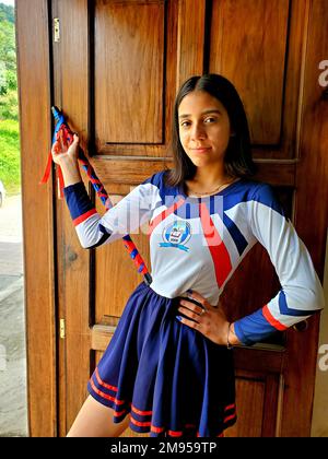 Cheerful Guatemalan high school girl in a marching band majorette costume during the Independence Day in rural Guatemala near Antigua Guatemala Stock Photo