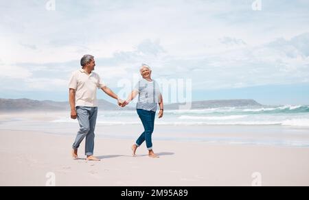 Theres always time for a stroll on the beach. a senior couple taking a walk on the beach. Stock Photo