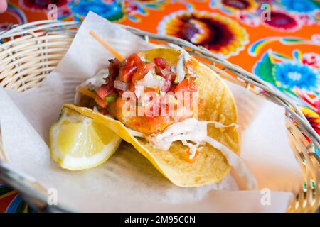 Shrimp tacos. A taco is a traditional Mexican food consisting of a small hand-sized corn tortilla Stock Photo