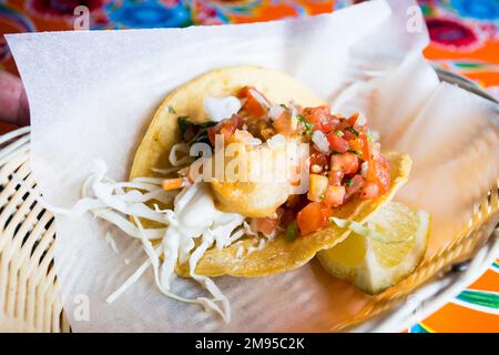 Shrimp tacos. A taco is a traditional Mexican food consisting of a small hand-sized corn tortilla Stock Photo