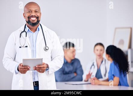 Were the best team of doctors. a mature male doctor using a digital tablet during a consultation at a clinic. Stock Photo