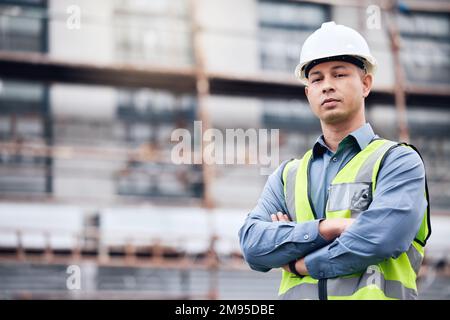 Lets build some new things. a mature male architect standing with his arms crossed at a building site. Stock Photo