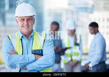 Doing the most important work. a senior building contractor looking proud during a meeting. Stock Photo
