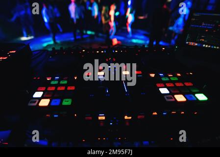 glowing buttons professional Board for mixing and music at party in night club with a dark colored background Stock Photo