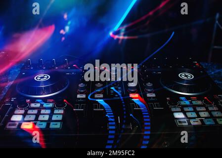 mixer and DJ booth in the nightclub at party c of bright multicolored effects with a dark background Stock Photo