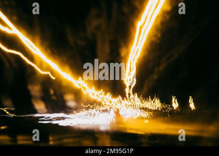 blurred abstract traces of bright night lights on the road Stock Photo