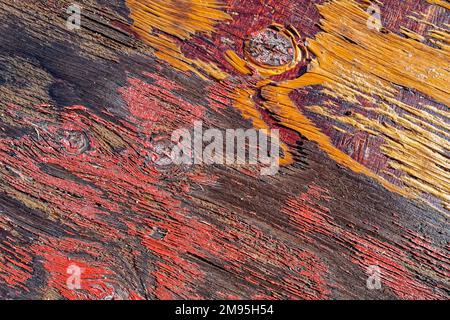 Fading paint peeling from a rotting wooden board Stock Photo
