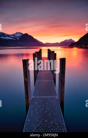 purple Lake landscape with mountains and a jetty Stock Photo - Alamy