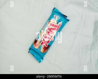 Twix minis cookie bars on blue background.Twix is a chocolate bar made by Mars, Inc. Stock Photo