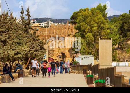 Jerash, Jordan - November 7, 2022: Tourists in front of Arch of Hadrian at the entrance of the archeological site Stock Photo