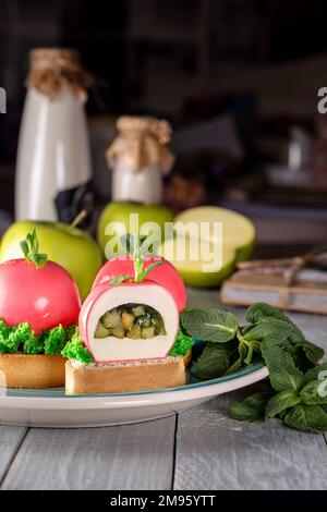Apples shaped mousse dessert with fruit compote on shortbread tartlets Stock Photo