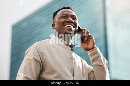 What news have you got for me. a handsome young businessman using his smartphone to make a phone call. Stock Photo