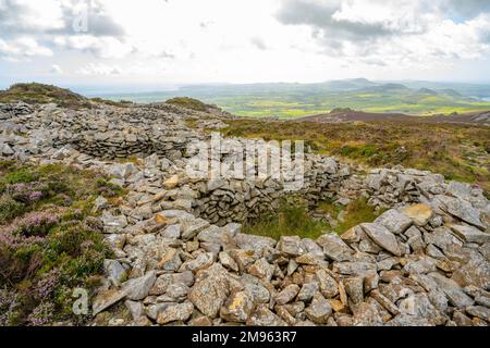 Round stone huts  the Iron Age hill fort of Tre'r Ceiri on the Llyn Peninsula Gwynedd North Wales Stock Photo