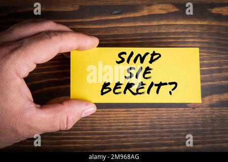 Are You Ready in German. Yellow piece of paper with text. Stock Photo