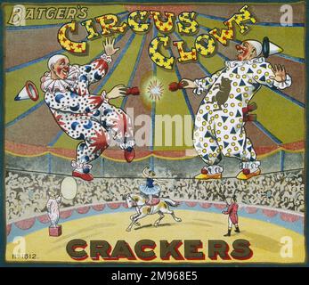 Label for a box of Batgers circus clown Christmas crackers featuring two daredevil clowns pulling a cracker high up on a tightrope in a circus big top. Stock Photo