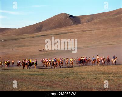 A horserace for youngsters during the annual Naadam Festival, in the countryside near Ulaanbaatar (or Ulan Bator), capital of Mongolia.  Typical games played during this competitive festival are wrestling, archery and horse racing. Stock Photo