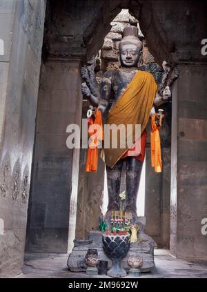 Statue of the Hindu god, Vishnu, in the Khmer temple of Angkor Wat, at Siem Reap, Cambodia.  The temple was first Hindu, then Buddhist. Stock Photo