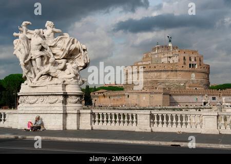 View of a large sculpture on the Vittorio Emanuele II Bridge across the River Tiber, with the Castel Sant'Angelo (sometimes also known as the Mausoleum of Hadrian) in the distance on the right, in Rome, Italy. Stock Photo