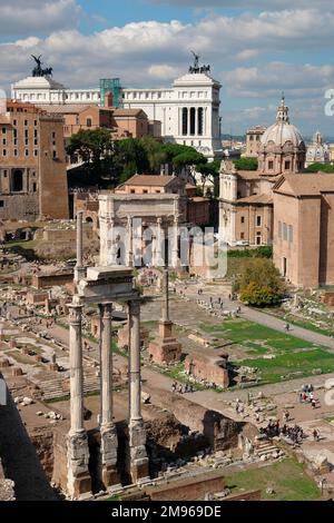 General view of the Roman Forum, or Forum Romanum, in Rome, Italy.  In the middle distance is the triumphal Arch of Septimius Severus, in white marble.  The large white building on the horizon is the Monument to Vittorio Emanuele II, and on the right is the domed church of Santi Luca e Martina. Stock Photo