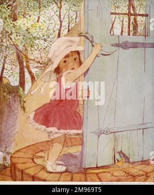 A sweet and engaging little girl in a red dress and wide-brimmed sun hat, opens a door using an old-fashioned latch. Stock Photo