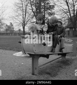 Smiling toddler girl riding playground basket swing Stock Photo - Alamy