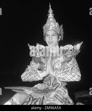 A Burmese solo male dancer in his traditional costume, holding his hands together.  The dance has ancient origins and is linked to Chinese, Indian, Indonesian and Thai styles. Stock Photo