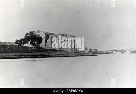 General view of Carew Castle, Pembrokeshire, Dyfed, South Wales, from across a stretch of water at high tide.  The castle dates from the 13th century. Stock Photo