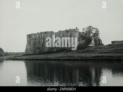 General view of Carew Castle, Pembrokeshire, Dyfed, South Wales, from across a stretch of water.  The castle dates from the 13th century. Stock Photo