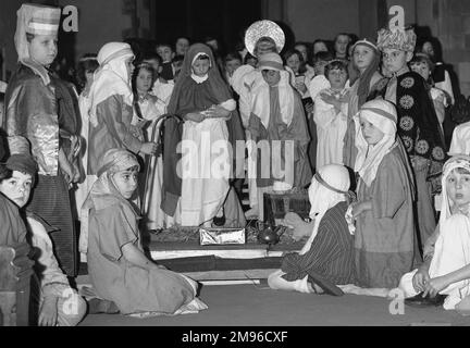 A group of children taking part in a nativity play at their school, with Mary and Joseph, angels, shepherds and wise men. Stock Photo