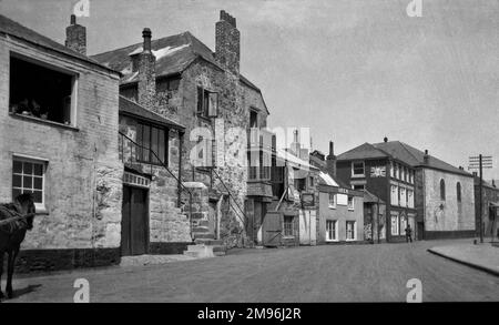 A street scene in St Ives, Cornwall, with houses and shops, and a sign advertising BP. Stock Photo