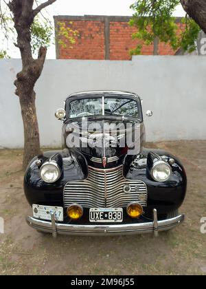 Lanus, Argentina - Sept 25, 2022: Old black 1940 Chevrolet Chevy Master 85 business coupe by GM in a park. Chromes. Grille. AAA 2022 classic car show. Stock Photo