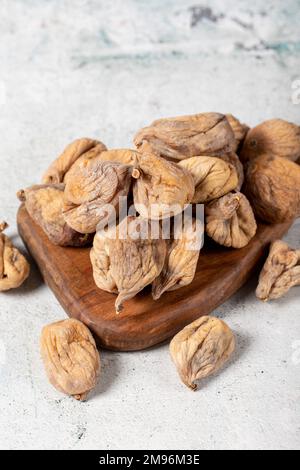 Dried figs on stone background. Sun-dried dried figs on a wooden serving board. Diet foods. close up Stock Photo
