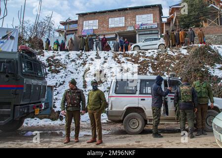 Srinagar, India. 16th Jan, 2023. Kashmiri people watch as Indian police officers stand guard at the shoot-out site at central Kashmir's Budgam. Two Lashkar-e-Taiba militants, who were travelling in a vehicle, were killed in a brief shoot-out with Indian government forces in Kashmir's Budgam district. Top Police official told duo militants had earlier escaped from the recent encounter in the same district. (Photo by Faisal Bashir/SOPA Images/Sipa USA) Credit: Sipa USA/Alamy Live News Stock Photo