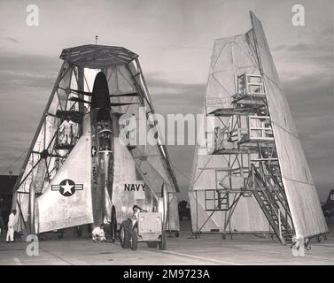 A tractor manoeuvres the Convair XFY-1 Pogo VTOL fighter into position for housing in its hangar at Brown Field Naval Auxialiary Station near San Diego, California. Stock Photo